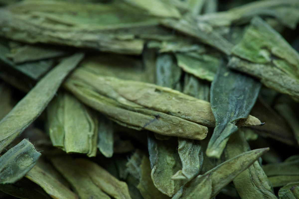 Dried green tea leaves in a close-up view